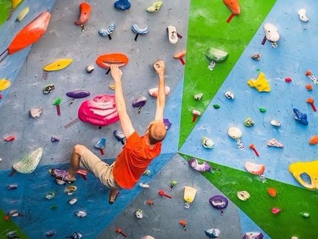 A man climbing the bouldering wall