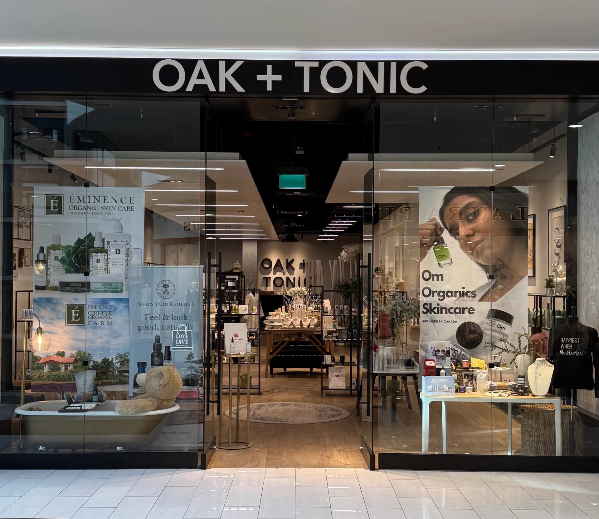 Oak + Tonic storefront with skincare product displays, posters and illuminated interior shelves.