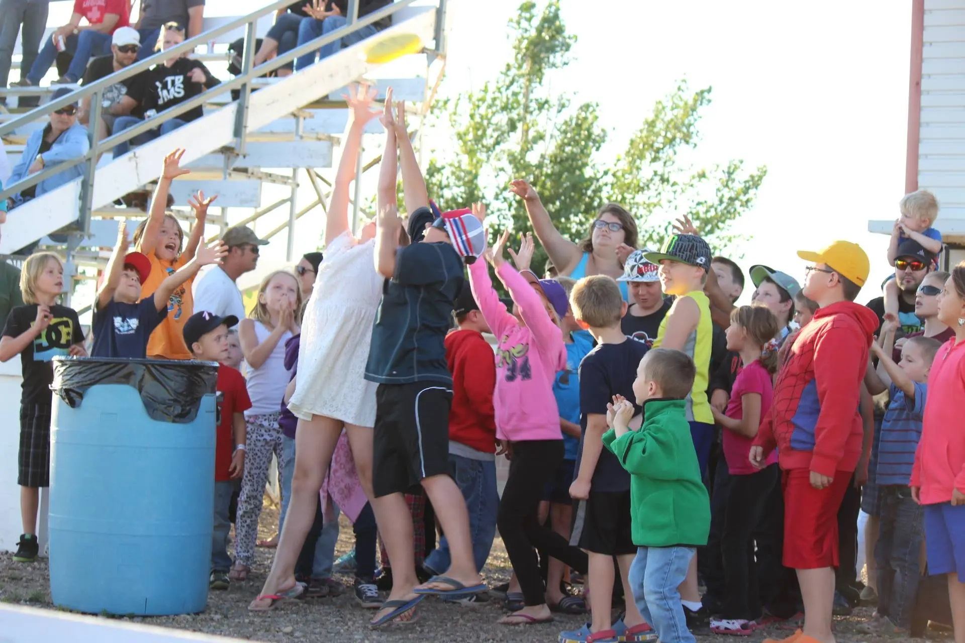 A crowd of children gathered cheering on the race.