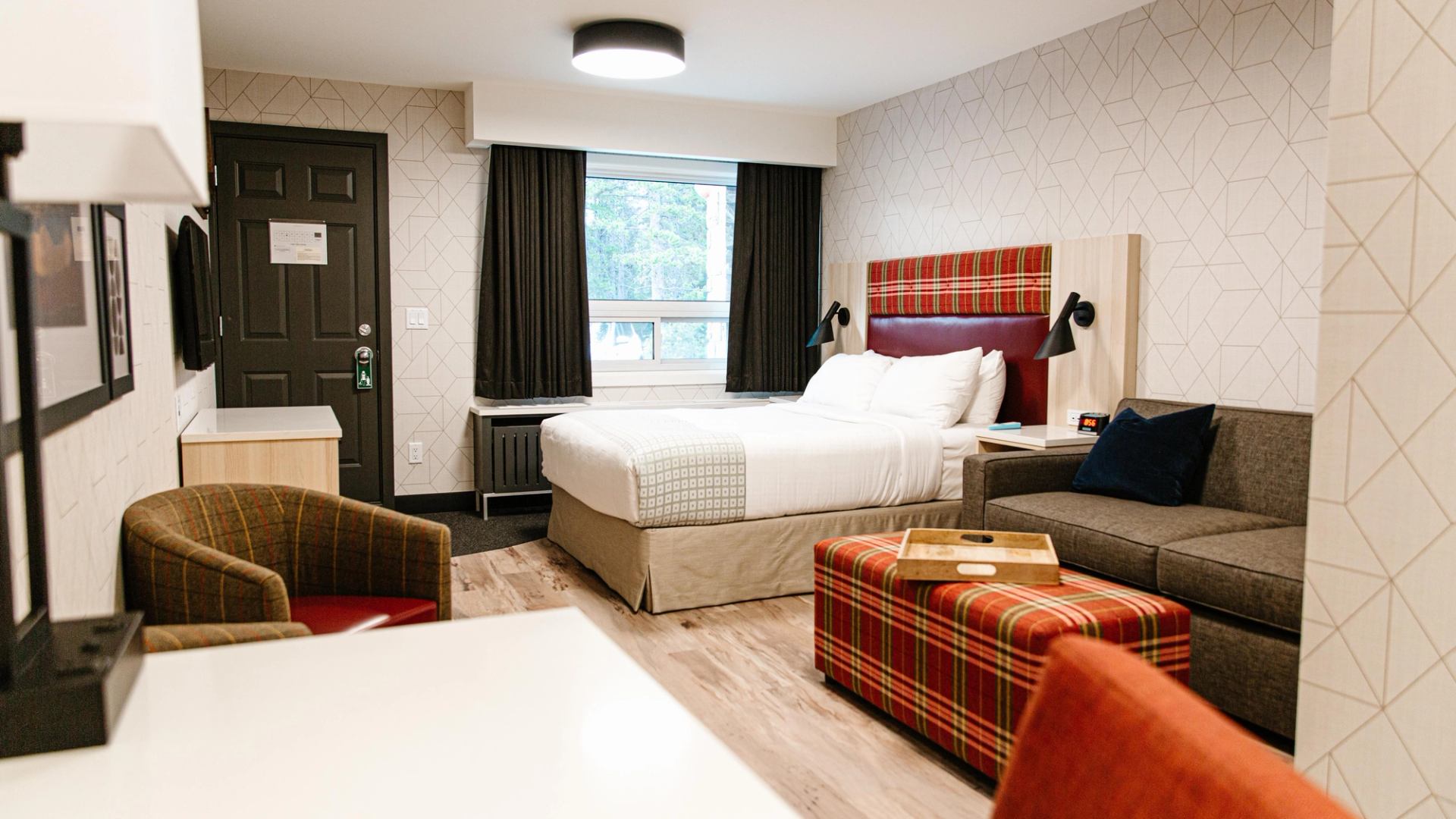 Classic guestroom at Mountaineer Lodge providing a warm, restful base for exploring Lake Louise.