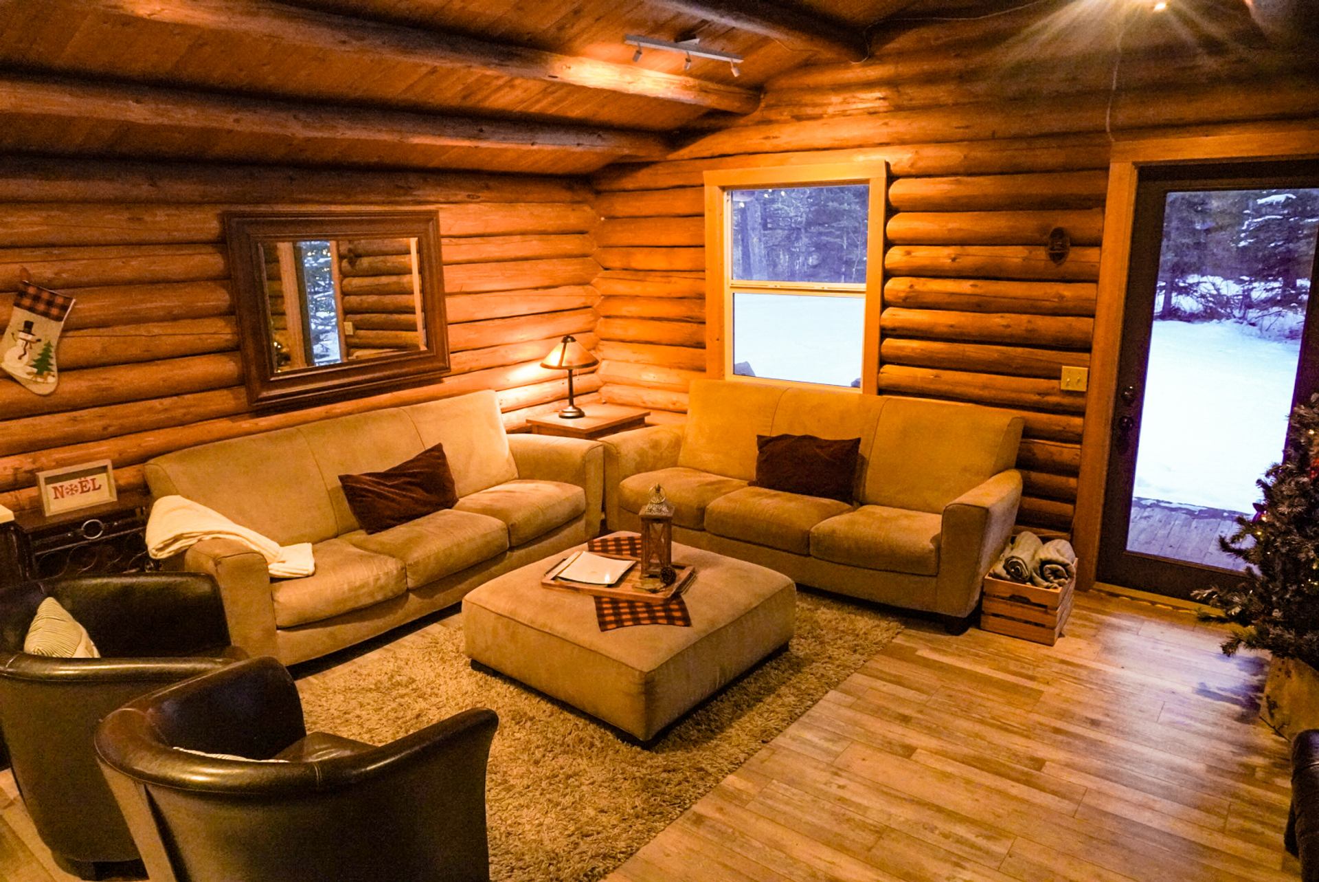 Warm log cabin living room with cozy seating and rustic decor at Trembling Aspen Retreat.