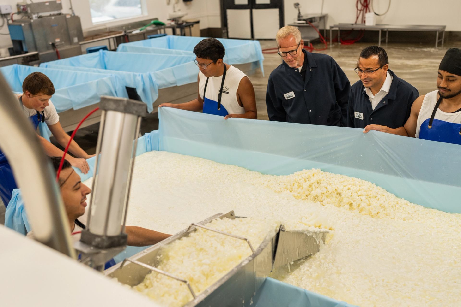 A group on a cheesemaking factory tour at Crystal Springs Cheese Factory.