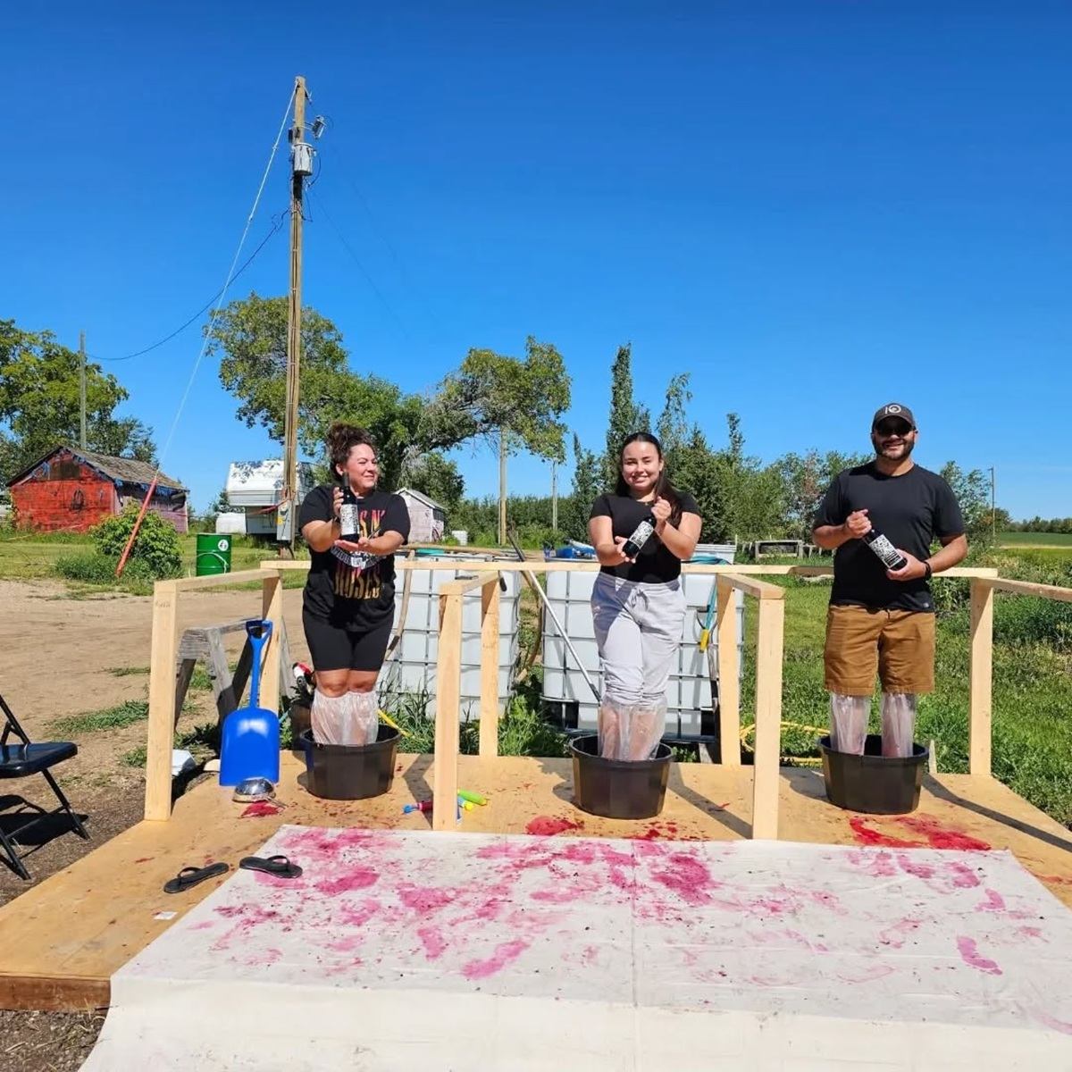 Reveresque hosts berry stomping as guests stand in tubs crushing fruit outdoors.