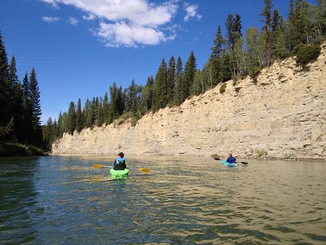 People kayaking down a river in David Thompson Country.