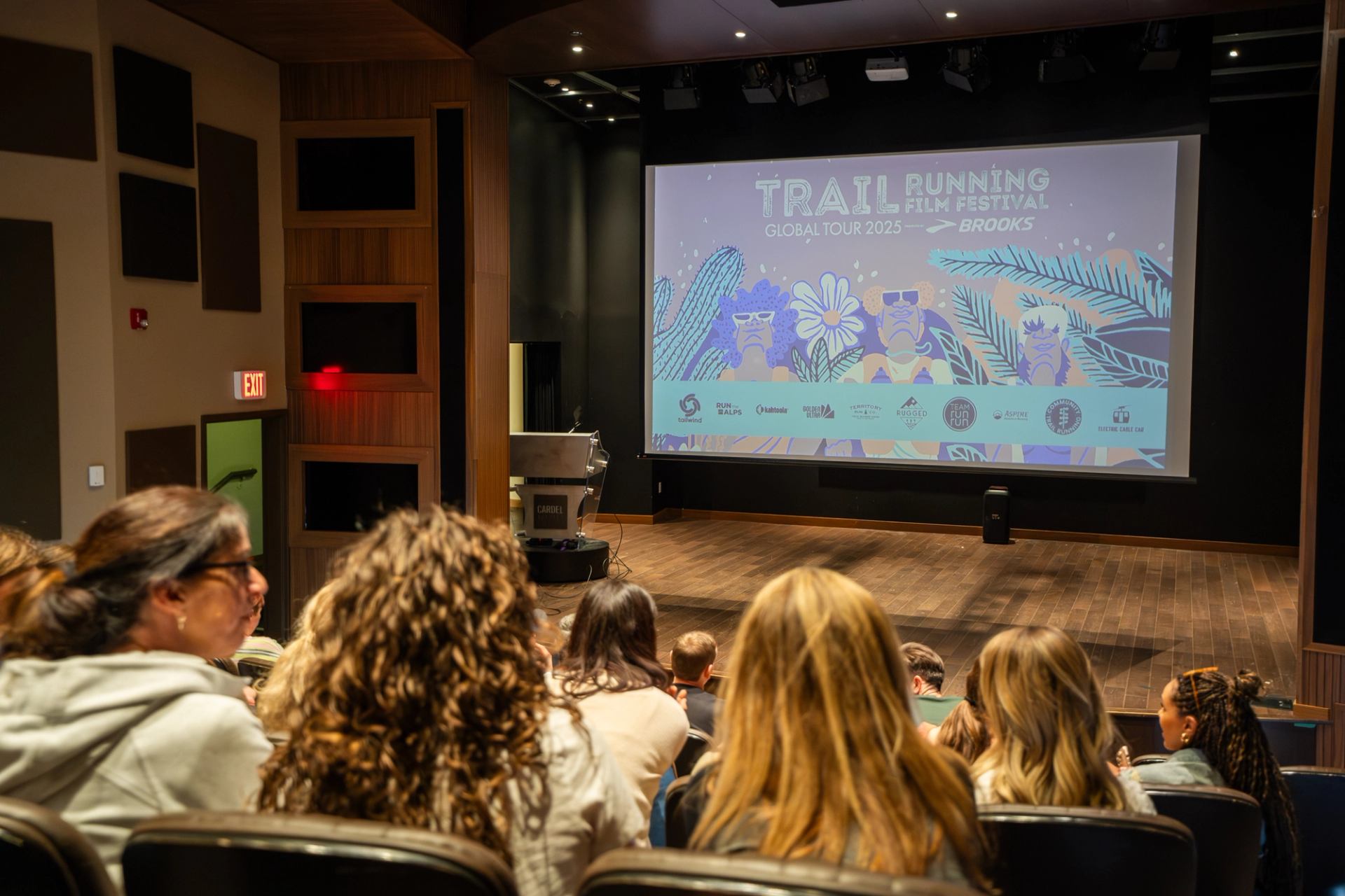 Audience sits in a theatre watching Trail Running Film Festival 2025 screen presentation.