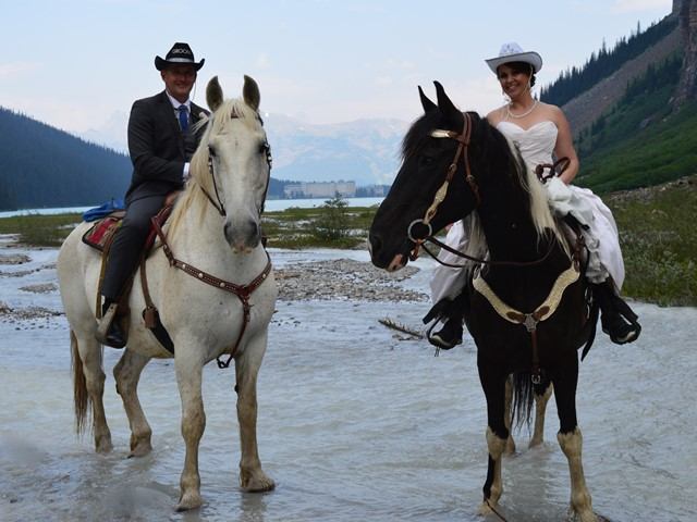 A bride and groom on horses