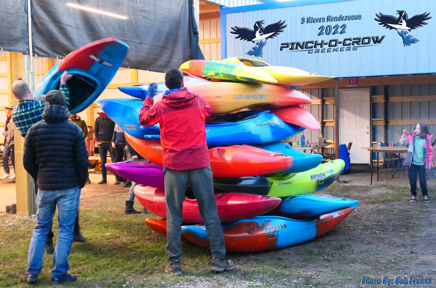 People taking their kayaks from the pile