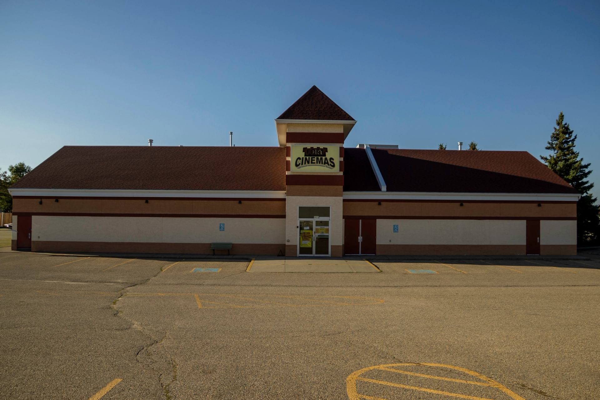 Exterior of Magic Lantern Fort Cinema with red roof and beige walls.