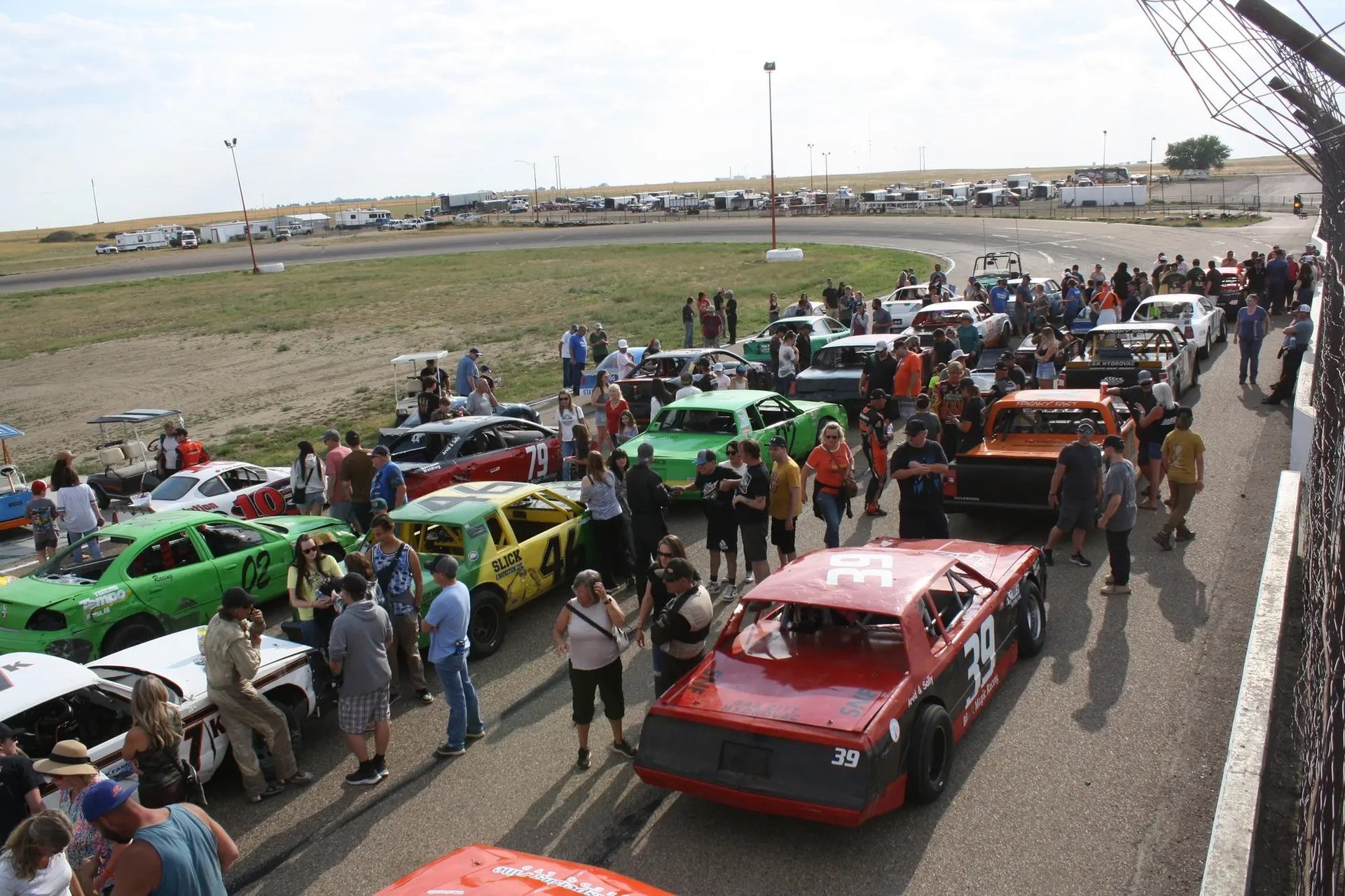 Cars and people lined up on the track