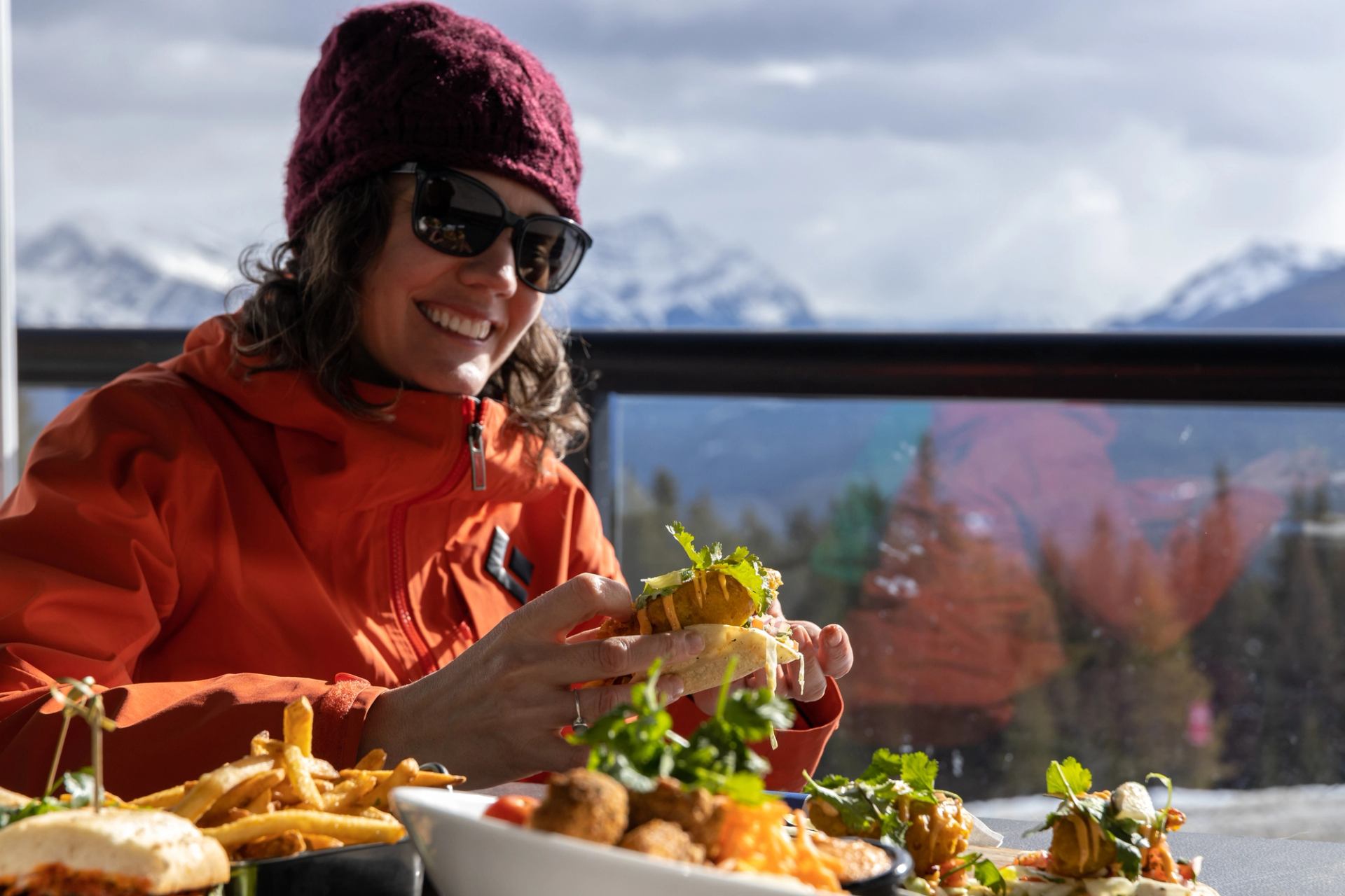 Woman enjoying food on the patio at Marmot Basin Ski Resort in Jasper National Park.