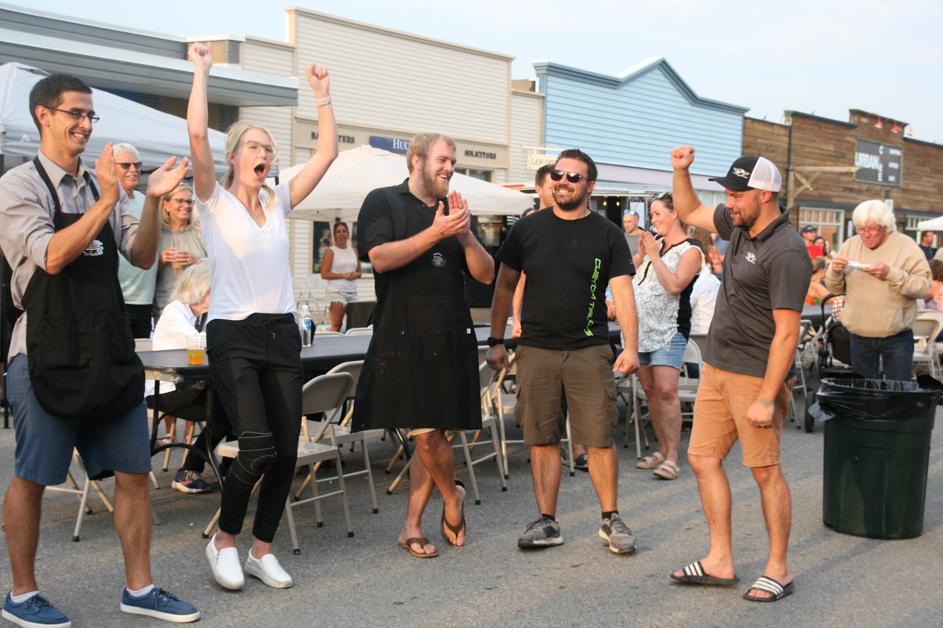 People celebrating and clapping at Taste of Fort Macleod.