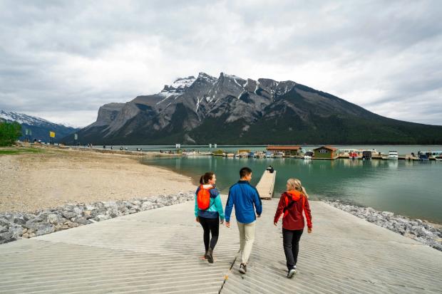 People walking on the dock towards Lake Minnewanka.