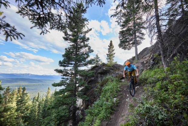 Person riding mountain a bike on a trail in Hinton.