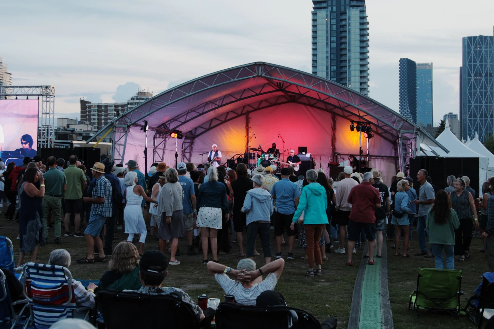 Crowd enjoying a live blues performance on an outdoor stage in Calgary