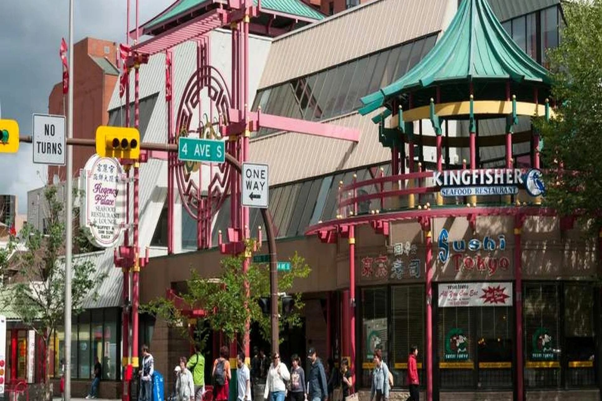 Pedestrians walk past restaurants and colourful architecture on 4 Avenue South.