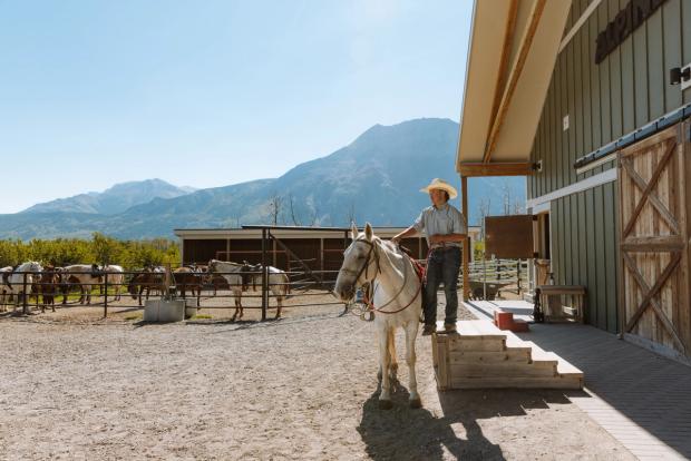 Employee giving instructions at Alpine Stables.