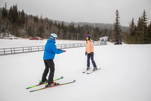 A ski instructor advises a skier on technique before skiing Hidden Valley Ski Resort.