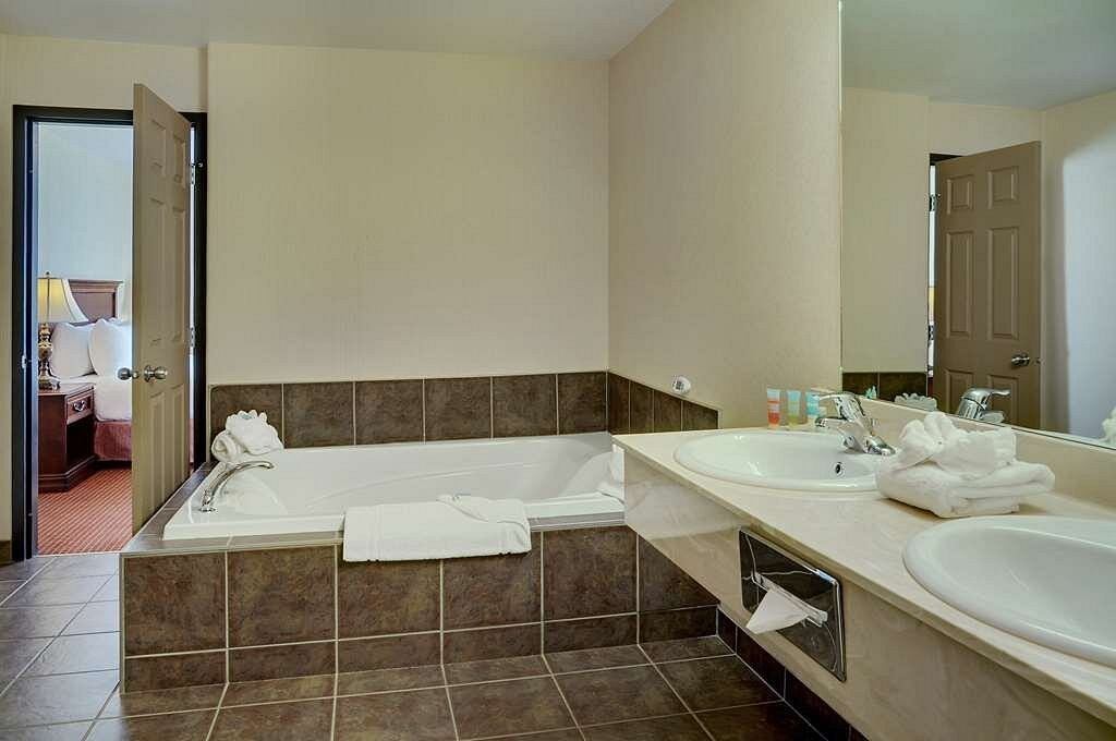 Spacious bathroom with double sinks and a large soaking tub.