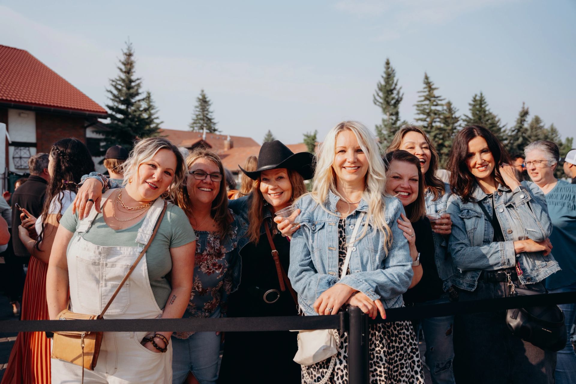 Group of attendees standing at the front rail before an outdoor show