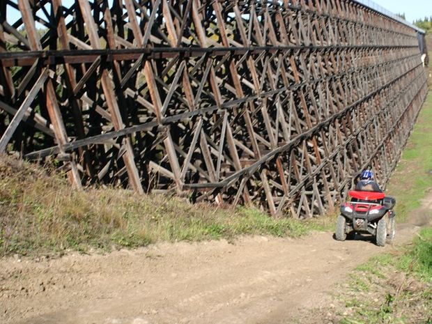 Person quading with Beaver River Trestle in the background.