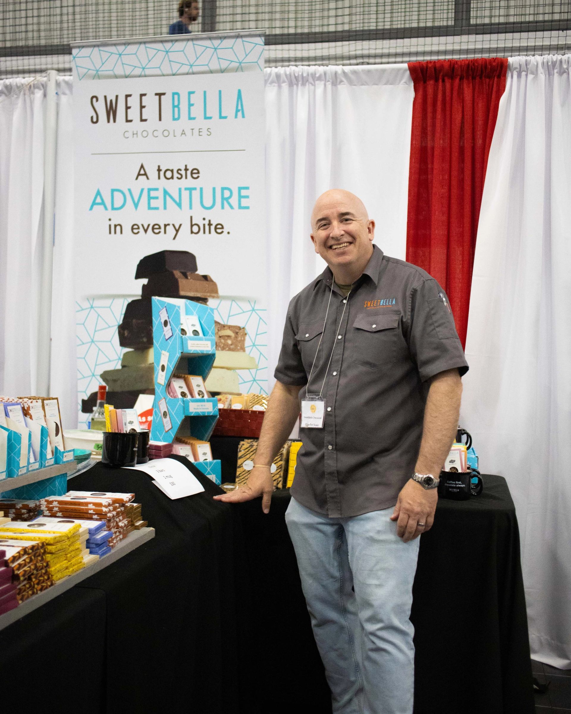 An exhibitor at ChocoFest shows his craft chocolate bars.