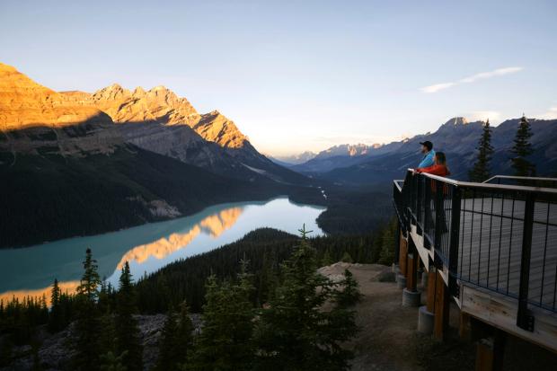 People standing on the observation lookout at Peyto Lake, in Banff National Park.