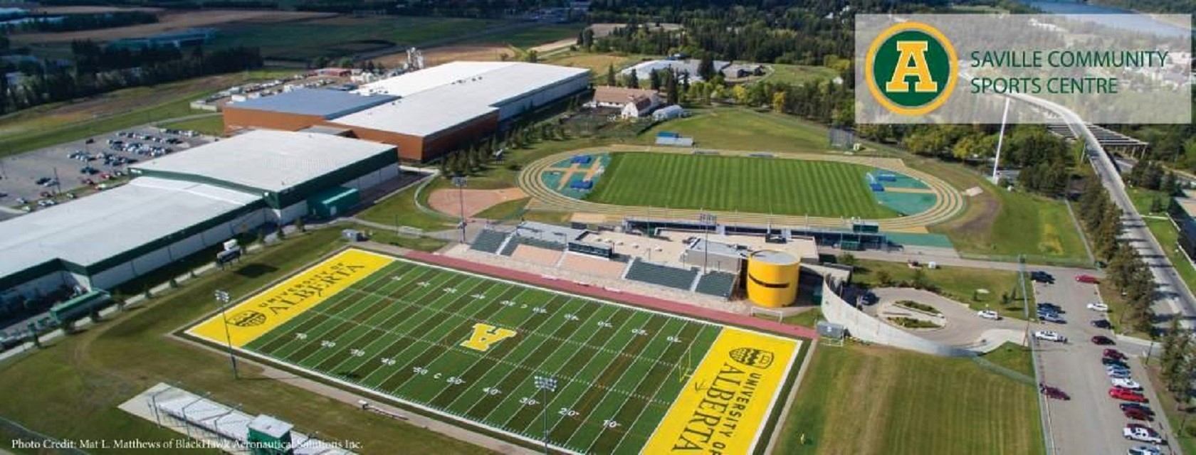 Aerial view of Saville Community Sports Centre with football field, track and buildings.