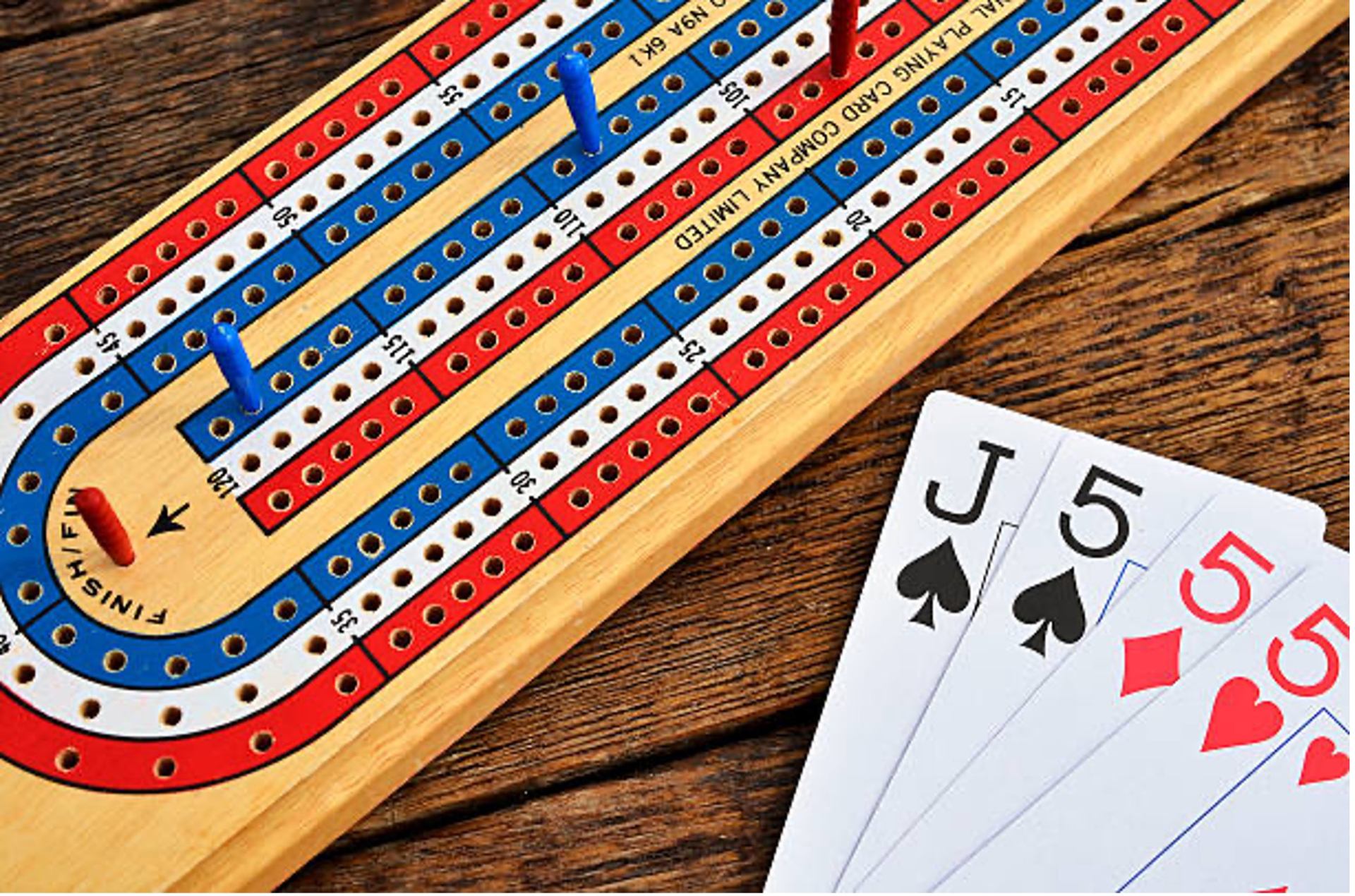 A crib board and a hand of cards.
