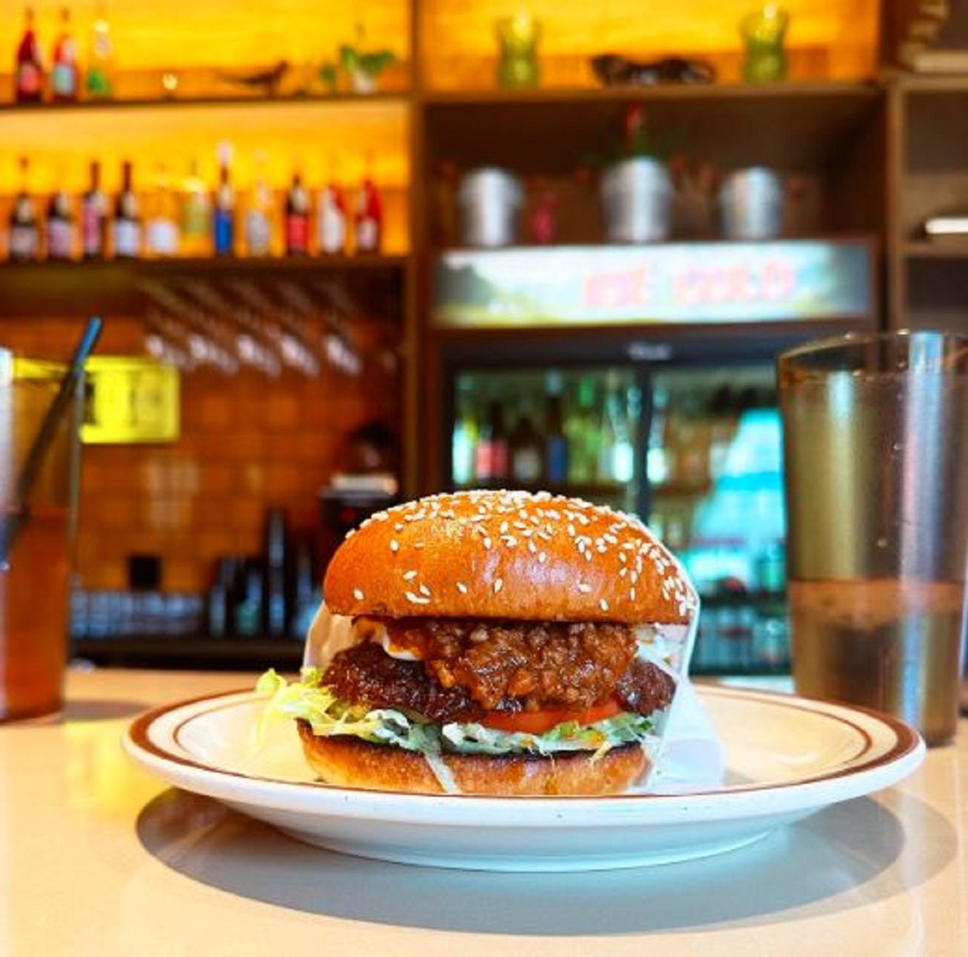 A Winnipeg Fat Boy Burger on a plate set on the counter.
