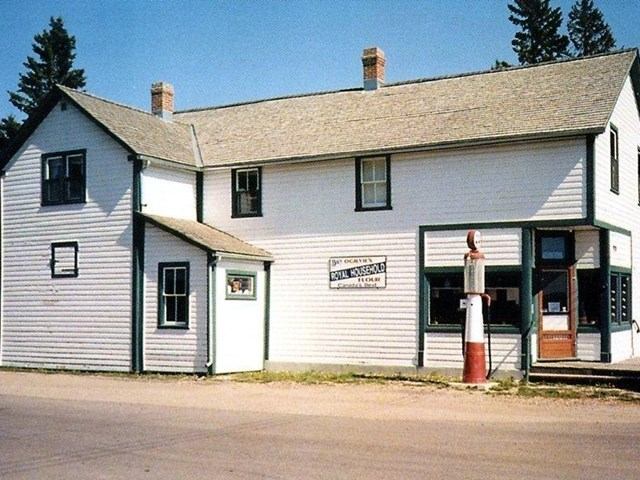 Dickson Store Museum, white two-story building with green trim and vintage gas pump.