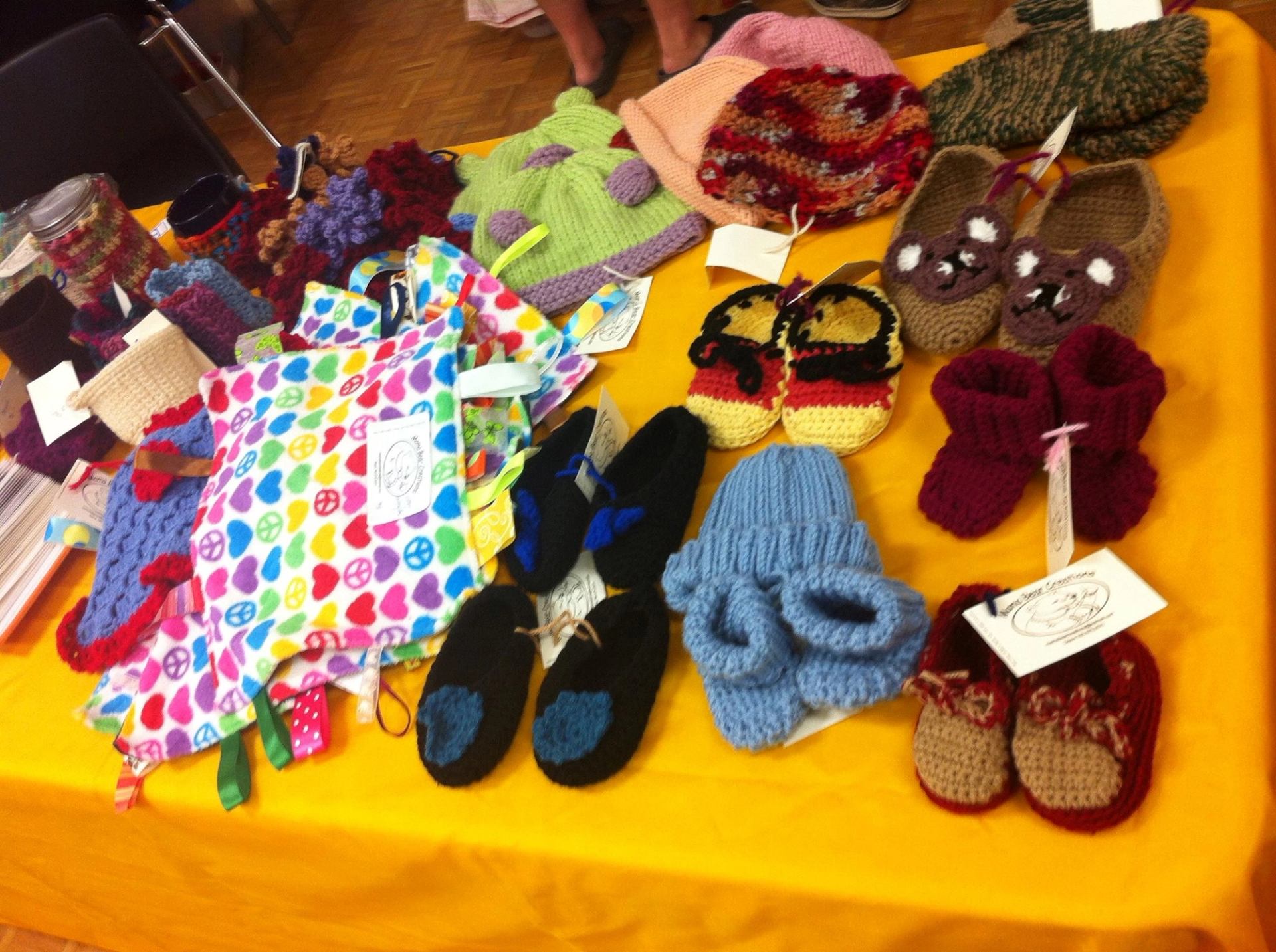Handmade knit and crochet items on display at Boyle Farmers' Market.