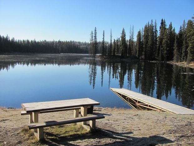 A scenic shot of picnic table and lake at Sundance Provincial Park.