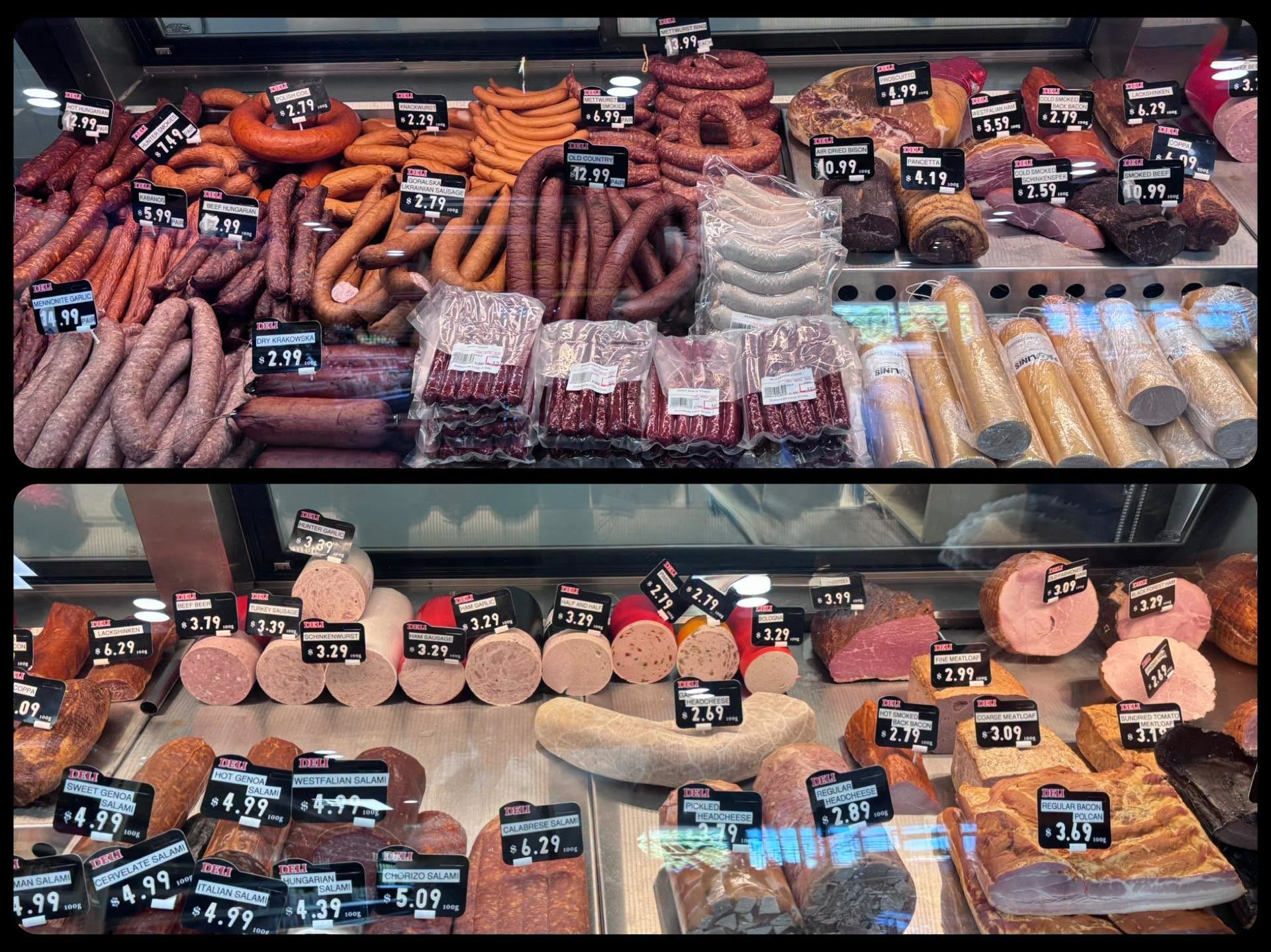 Deli display case filled with European sausages, cured meats, salami, and specialty products.