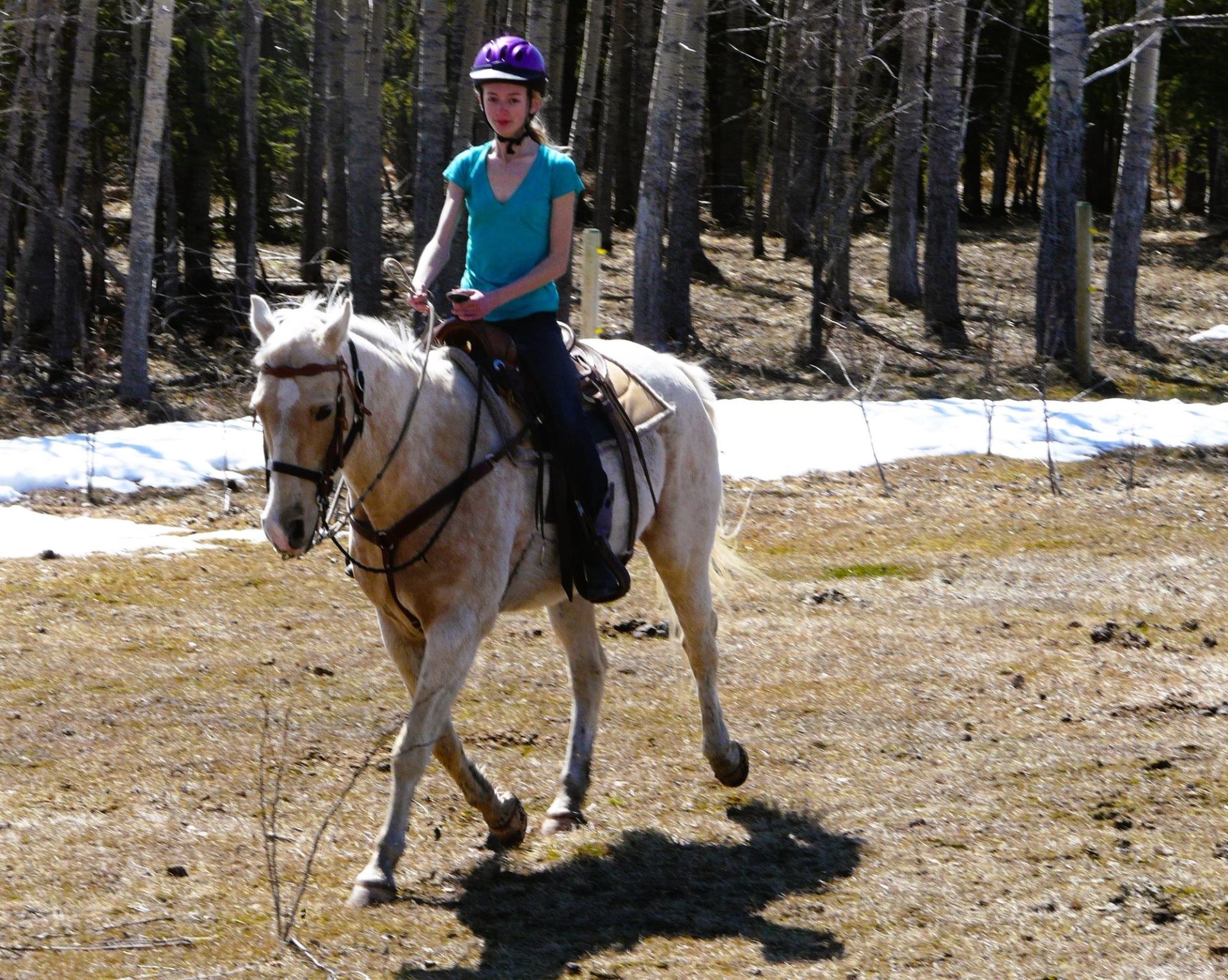 A girl riding her horse