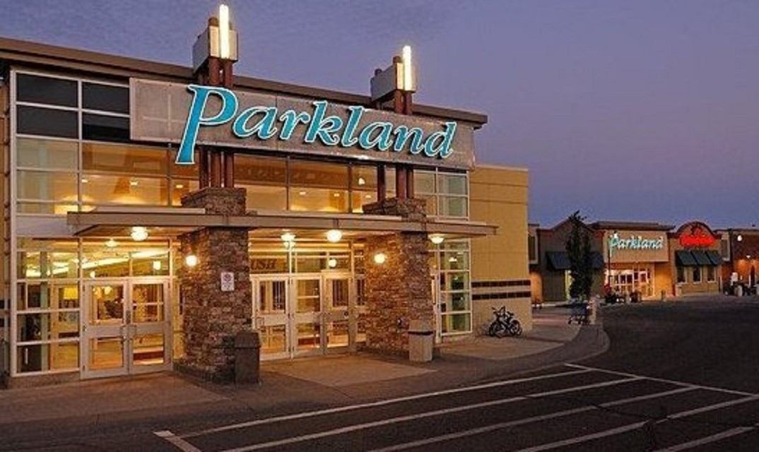 Parkland Mall entrance lit up at dusk with empty parking lot