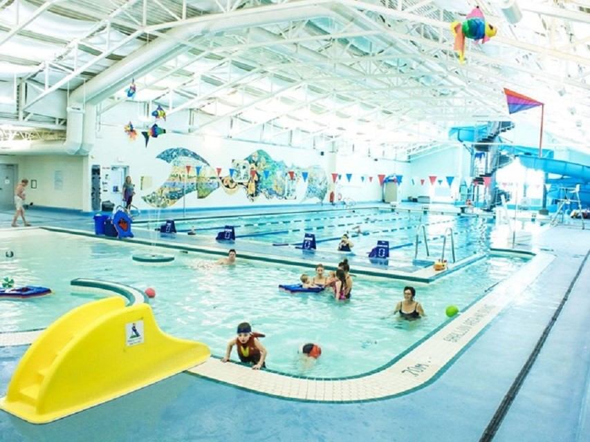 Colorful aquatic center with families.