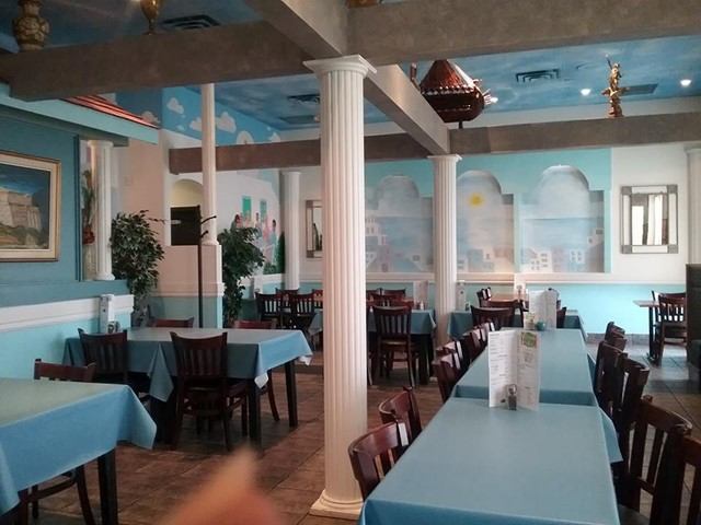 Greek-themed restaurant with blue decor and white columns.