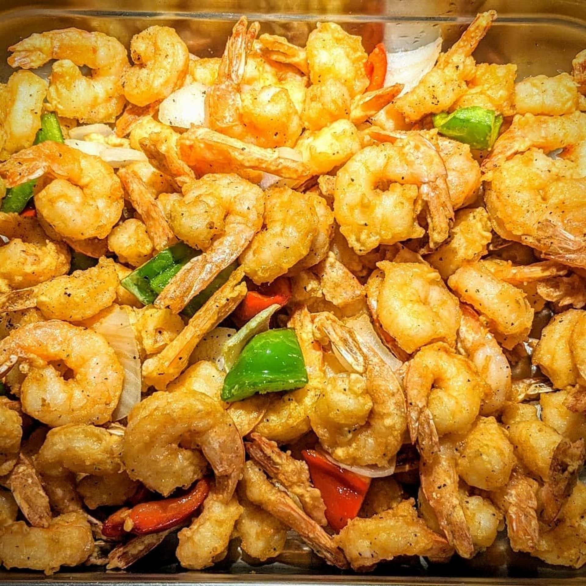 Fried shrimp with peppers and onions at JB Grill & Bar.