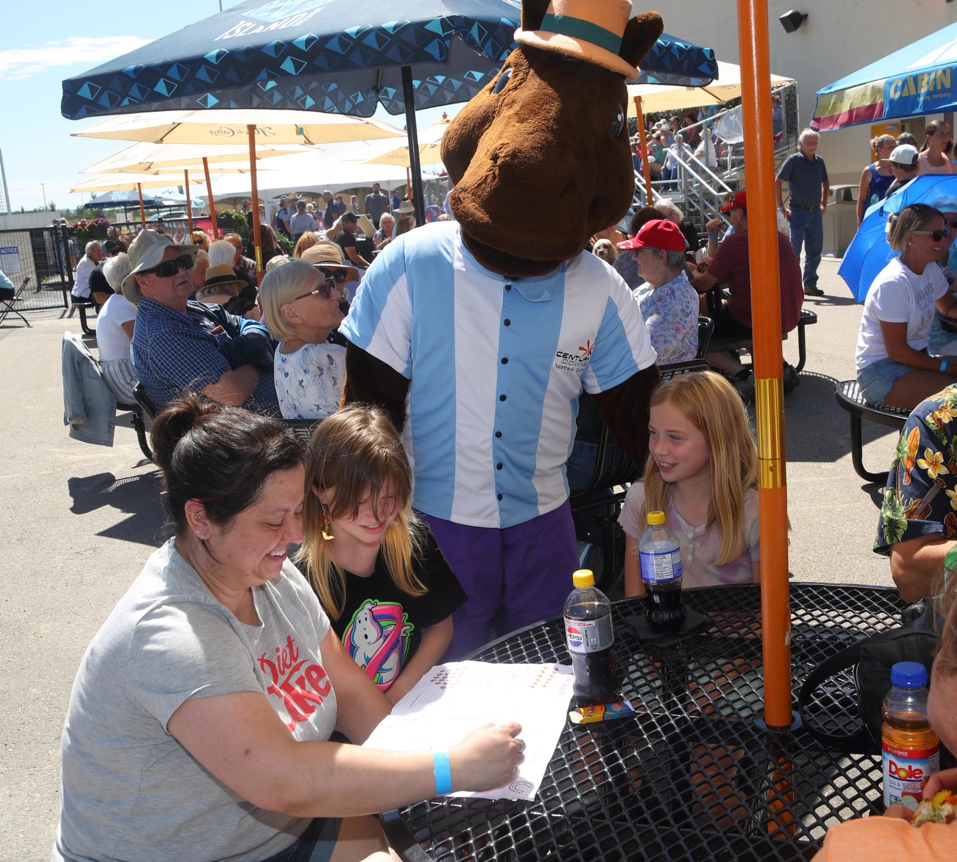 A family enjoying a festive brunch at the racetrack, celebrating Mother's Day with smiles and laughter.