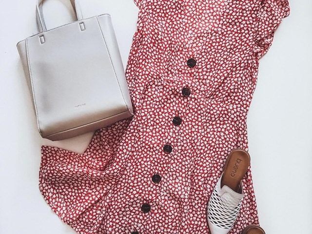 Handbag and folded red patterned fabric with black buttons and matching shoe.