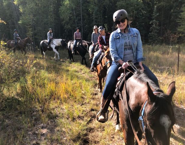 A group of people on a trail ride.