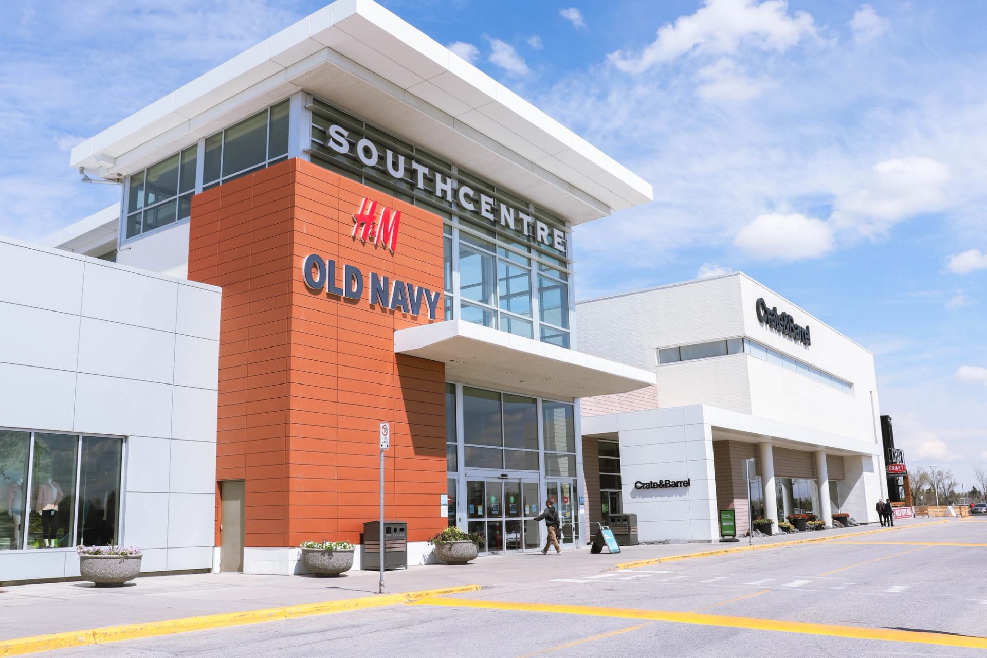 Southcentre Mall entrance with H&M and Old Navy signs on a modern glass-paneled facade.