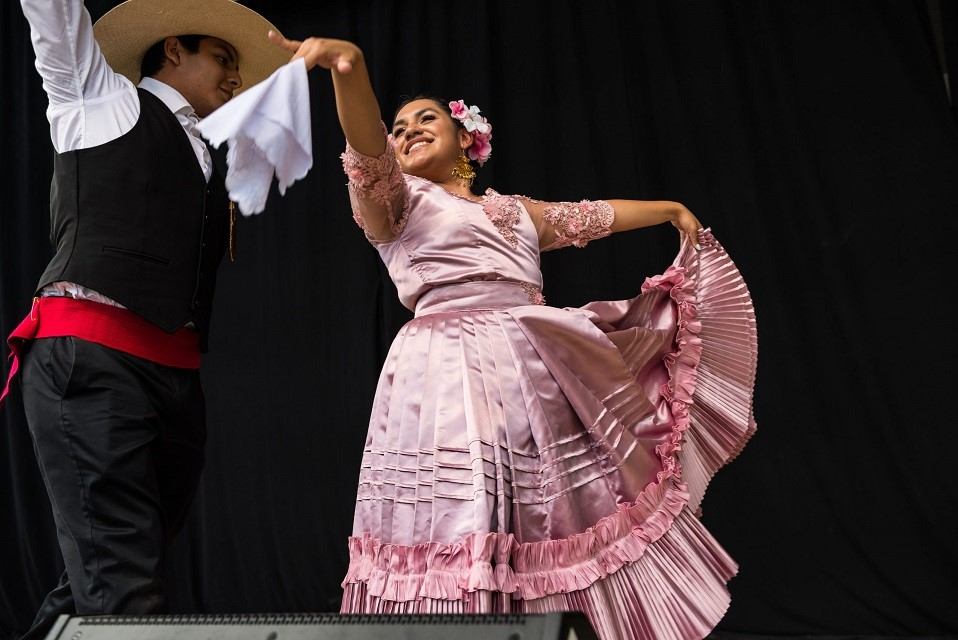 Expo Latino performers in traditional dance costumes.