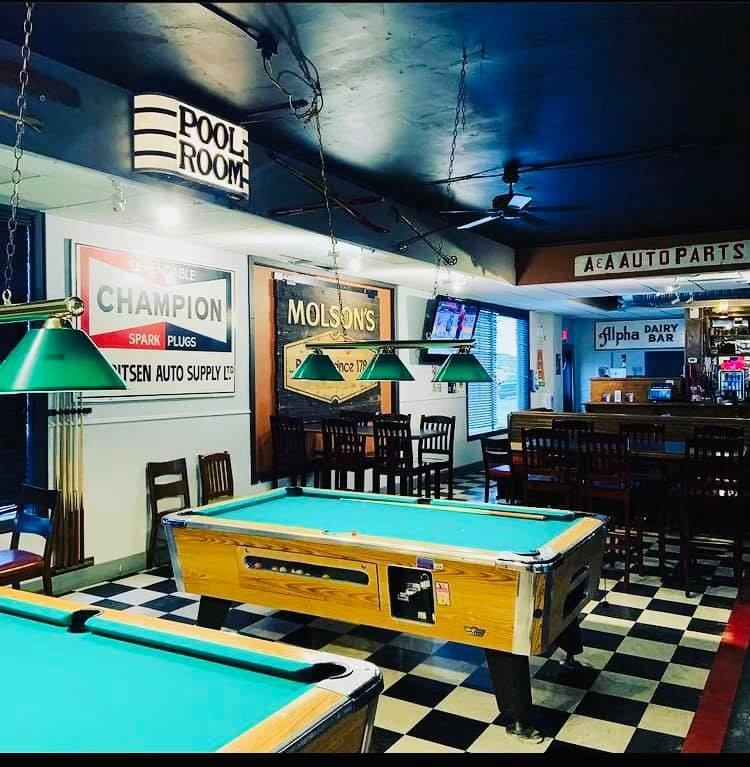 Pool tables in Track’s Pub with vintage signs and seating