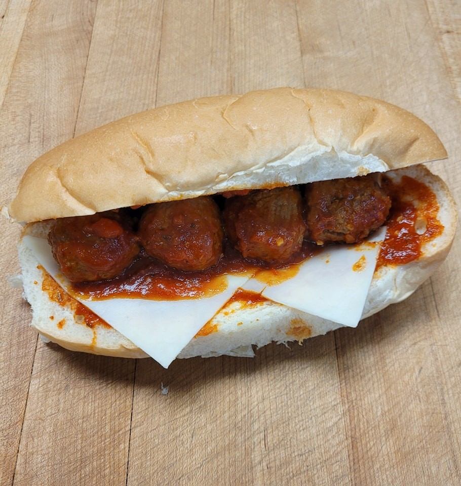 Meatball sub with marinara sauce and cheese on a fresh bun at Lakeview Bakery & Deli.
