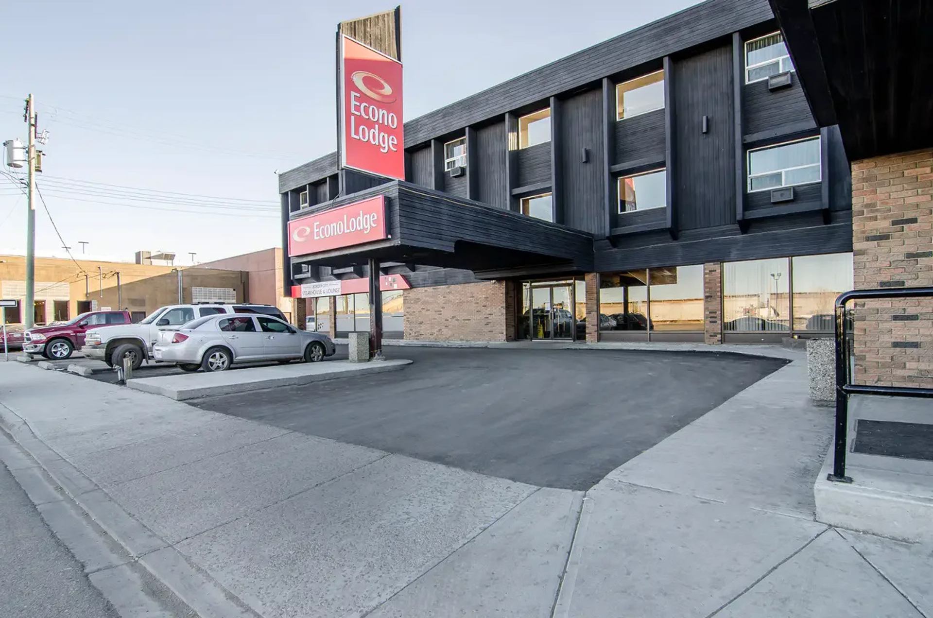 Econo Lodge Lloydminster exterior with a covered entrance, parking area, and prominent hotel signage.