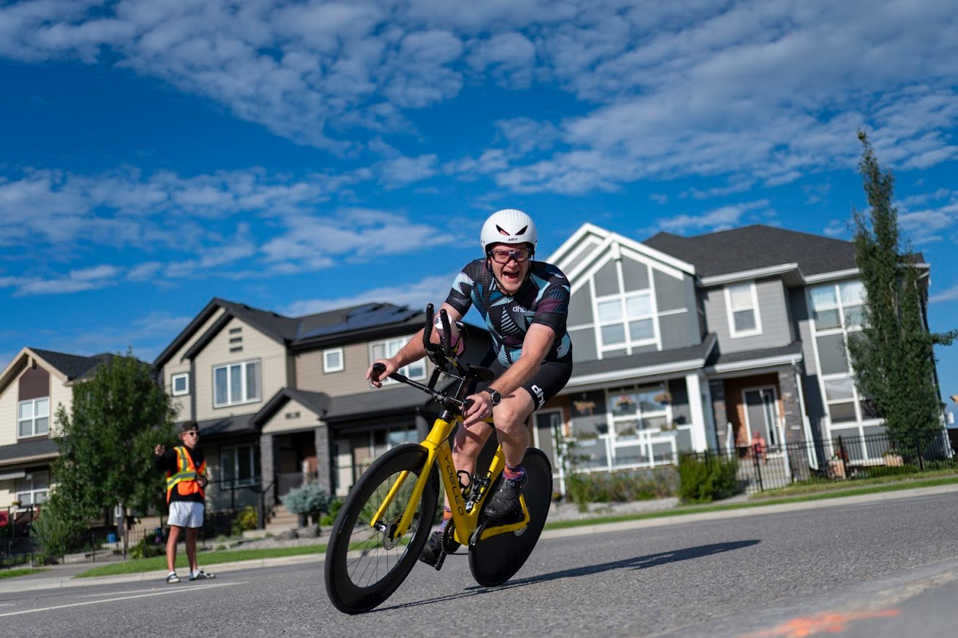 Cyclist speeding through a residential street during the Lake Chaparral Triathlon.