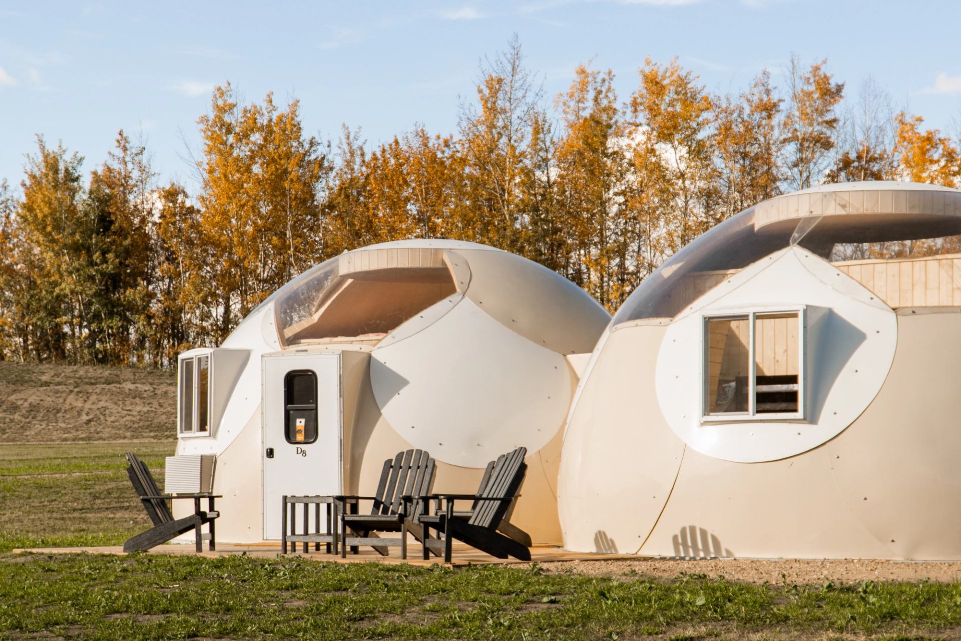 White sky domes with chairs outside.
