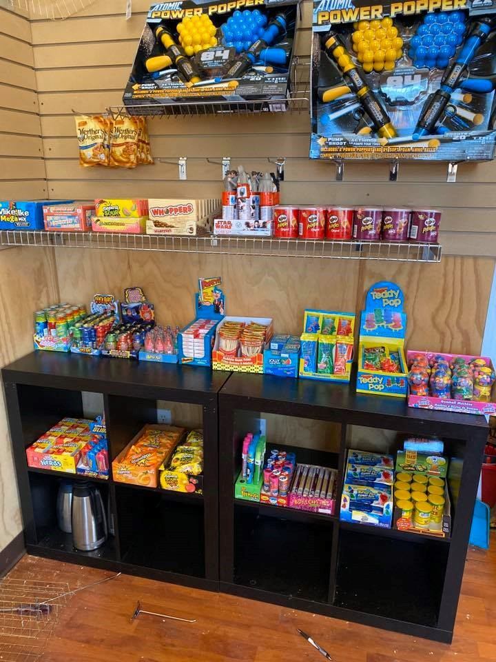 Store shelf with colorful candy and snacks displayed