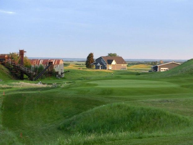 The golf course with the club house in the background.